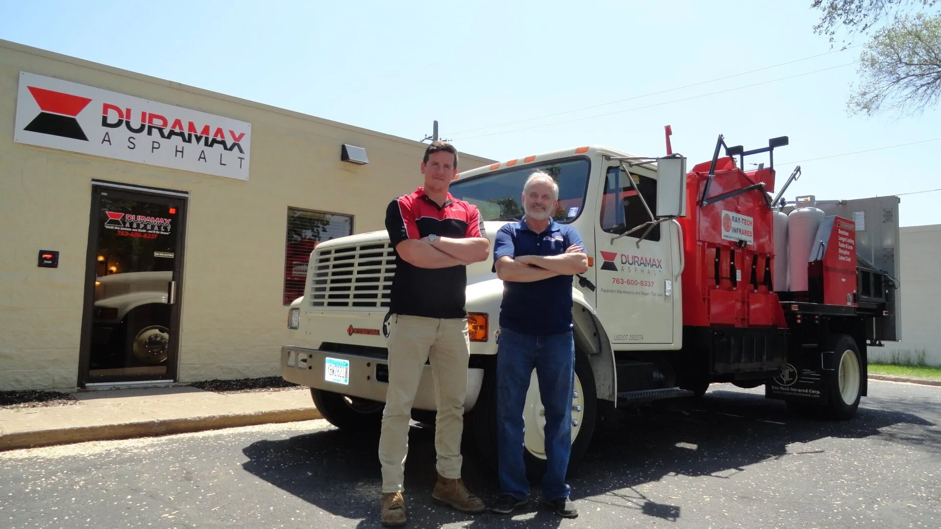 Owners of Duramax Asphalt standing next to work truck